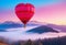 Beautiful red air balloon heart shape against blue and pink pastel sky in a sunny bright morning