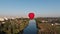 A beautiful red balloon flies in the evening over the river and the city
