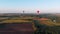 A beautiful red balloon flies in the evening over the river and the city