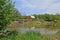 Beautiful red barn on the eroding banks of a river