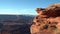 Beautiful red cliff at canyonlands with canyons in background