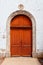 Beautiful red door in the church of the village Loix-en-Re