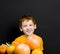 a beautiful red-haired boy with citrus fruits