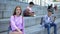 Beautiful red-haired teenager sitting stairs smiling camera, student exchange