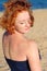 Beautiful red-haired woman at a beach