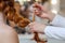 Beautiful, red hairy girl, hairdresser weaves a French braid, close-up in a beauty salon.