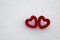 Beautiful red hearts on white snow background