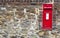 Beautiful red mailbox built into a stone wall