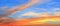 Beautiful red and orange cloud formations at sunrise in a panorama sky view