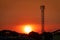 Beautiful red and orange sunset sky. Silhouette telecommunication tower in the evening with beautiful red sunset sky and clouds.