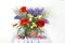 Beautiful red Poppies, Lupines, Irises in a vase isolated on a white background