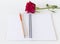 Beautiful red rose ,notebook white background.