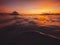 Beautiful red sunset at seascape with boats, jetty, sky and sea.