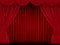 Beautiful red theatre folded curtain drapes on black stage