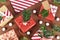 Beautiful red, white and natural brown decorated Christmas gift boxes with ribbons and fir branches on brown background