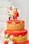 Beautiful red and yellow wedding cake in Indian style