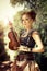 Beautiful redhair woman with body art on her face holding violin