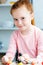 beautiful redhead schoolgirl holding molecular model and smiling