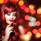 Beautiful redhead woman with long wavy hair on nightly bokeh