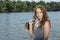 Beautiful redhead woman poses near water