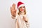 Beautiful redhead woman wearing christmas hat wearing pretend mustache over  background with open hand doing stop sign