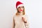 Beautiful redhead woman wearing christmas hat wearing pretend mustache over isolated background with a confident expression on