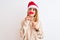 Beautiful redhead woman wearing christmas hat wearing pretend mustache over isolated background serious face thinking about