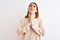 Beautiful redhead woman wearing winter turtleneck sweater over  background begging and praying with hands together with