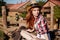 Beautiful redhead young woman cowgirl in hat