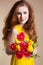 Beautiful redheared girl with bouquet of tulips