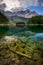 Beautiful reflection of highest mountain peak Zugspitze at Eibsee lake and amazing stormy clouds, Bavaria, Germany.