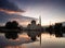 Beautiful reflection of mosque with sunrise background