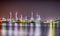 Beautiful reflection of Oil refineries located along the river with dark sky background-Image
