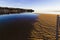 Beautiful reflection of the small village of Red Wharf Bay on the surface of the incoming tide, Isle of Anglesey, North Wales