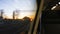 Beautiful reflection view of red sunset sky seen from moving modern train window, opposite seat is empty slow motion.