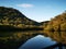 Beautiful reflections of blue sky, mountains and trees on creek