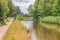 Beautiful reflections on the empty path along the Leeds-Liverpool canal near Burscough on a bright summer day