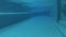 Beautiful refreshing blue swimming pool water in luxury tropical hotel. Night dark view. Action camera