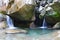Beautiful refreshing waterfall among the rocks of mountain creek