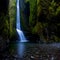 Beautiful remote waterfall in lush mossy canyon