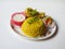 Beautiful restaurant style home made Chicken Biryani with two leg pieces and yogurt dip in a plate isolated on white background