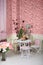 Beautiful retro interior with table, chairs, pink wallpaper