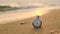 Beautiful retro vintage old shiny stopwatch lies on beach at sunset or sunrise and counts down time. Chromed stopwatch