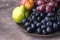 Beautiful Ripe Fruits on Plate Apple Pears and Grapes Dark Photo Dark Background Autumn Seasonal Fruits Above