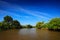 Beautiful river landscape from Costa Rica. River Rio Frio in the tropic forest. Stones in the stream. Trees above the water. Summe