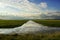 Beautiful river receding into the distance with reflection of clouds