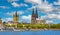 Beautiful river rhine waterfront skyline, two churches, dom, cruise ships, blue summer sky fluffy white clouds