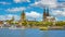 Beautiful river rhine waterfront skyline, two churches, dom, cruise ships, blue summer sky fluffy white clouds