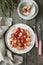 Beautiful roasted radishes served with thyme and sesame seeds in a plate on wooden rustic background