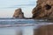 Beautiful rock cliff deux jumeaux in sunset sky on sandy beach of hendaye, basque country, france